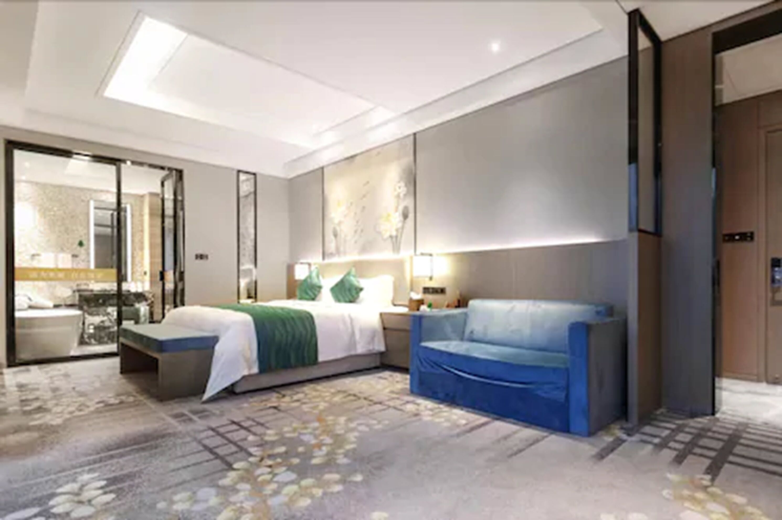 Una habitació d'hotel moderna amb un llit, un sofà blau, un escriptori i un mirall gran.