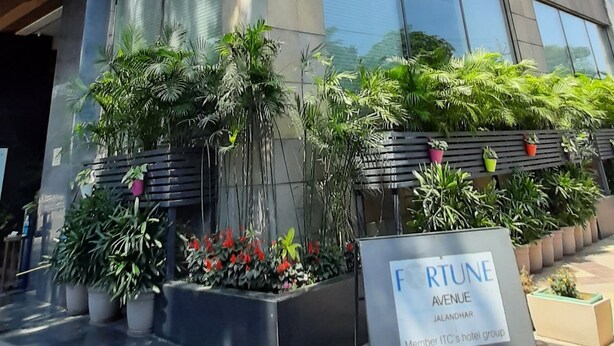 A modern building with large windows and a sign reading "FORTUNE AVENUE JALANDHAR Member ITC's hotel group".