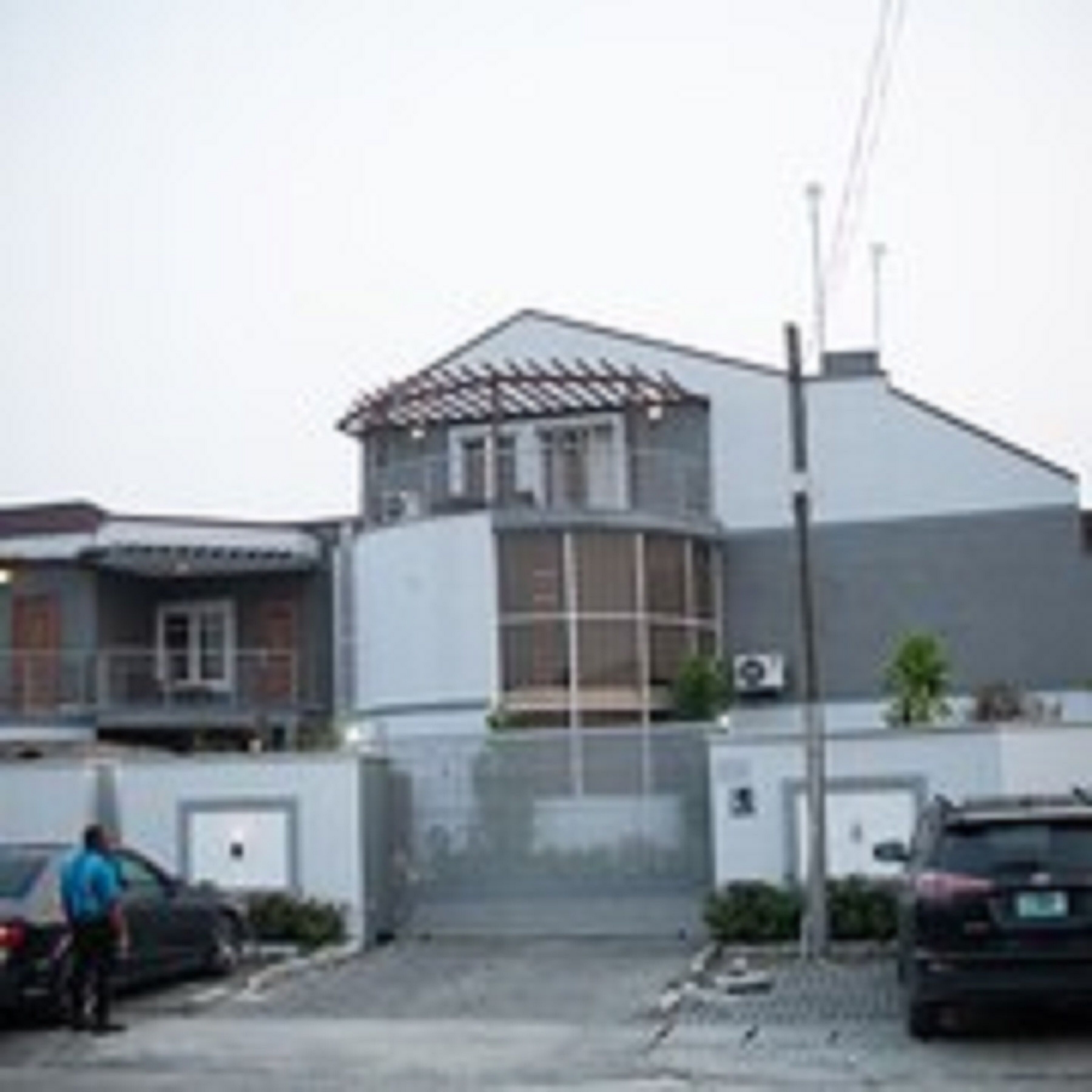 A modern two-story house with a garage and a covered porch.