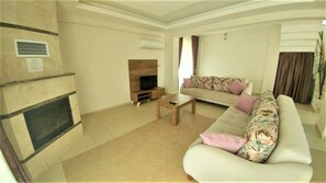 Villa | Living room | LCD TV, fireplace