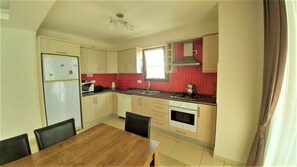 Villa | Private kitchen | Full-sized fridge, microwave, oven, stovetop