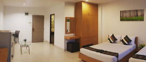 A hotel room with a bed, bedside tables, a desk, a chair, a TV, and a painting on the wall.