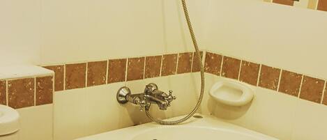A bathroom with a toilet, a sink, and a bathtub.