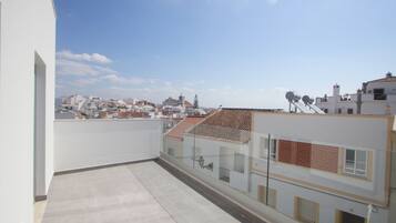 A rooftop terrace with a clear view of the cityscape.