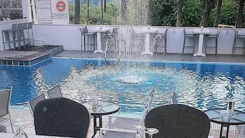 Seasonal outdoor pool, open 9:00 AM to 7:00 PM, pool umbrellas