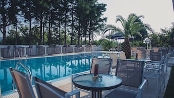 Seasonal outdoor pool, open 9:00 AM to 7:00 PM, pool umbrellas