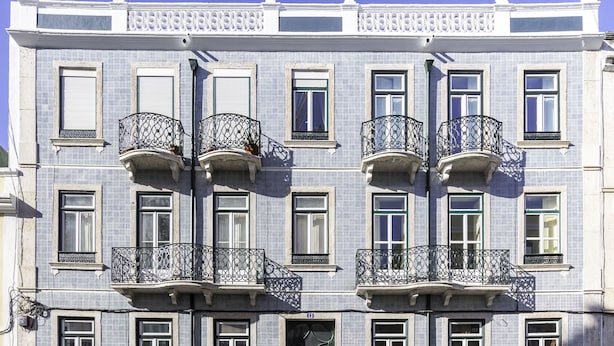 A multi-story building with balconies, large windows, and decorative statues on the roof. - GuestHouse - Deluxe Double Room with Balcony (Room 8 Seraphim ) (Lisboa)