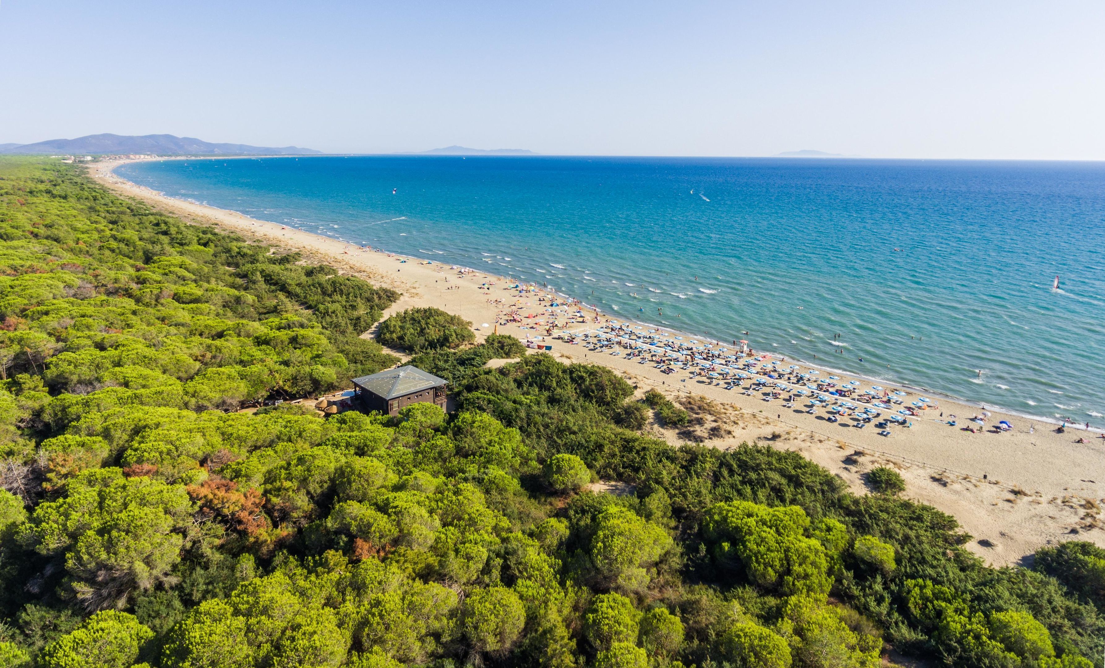 On the beach, white sand, sun-loungers, beach umbrellas