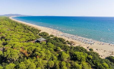 On the beach, white sand, sun loungers, beach umbrellas