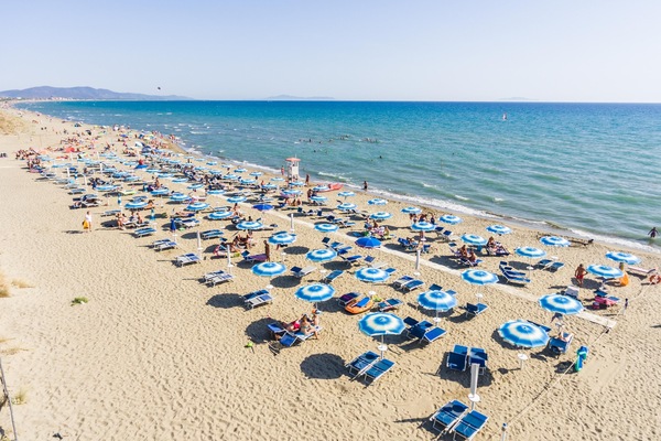 On the beach, white sand, sun loungers, beach umbrellas