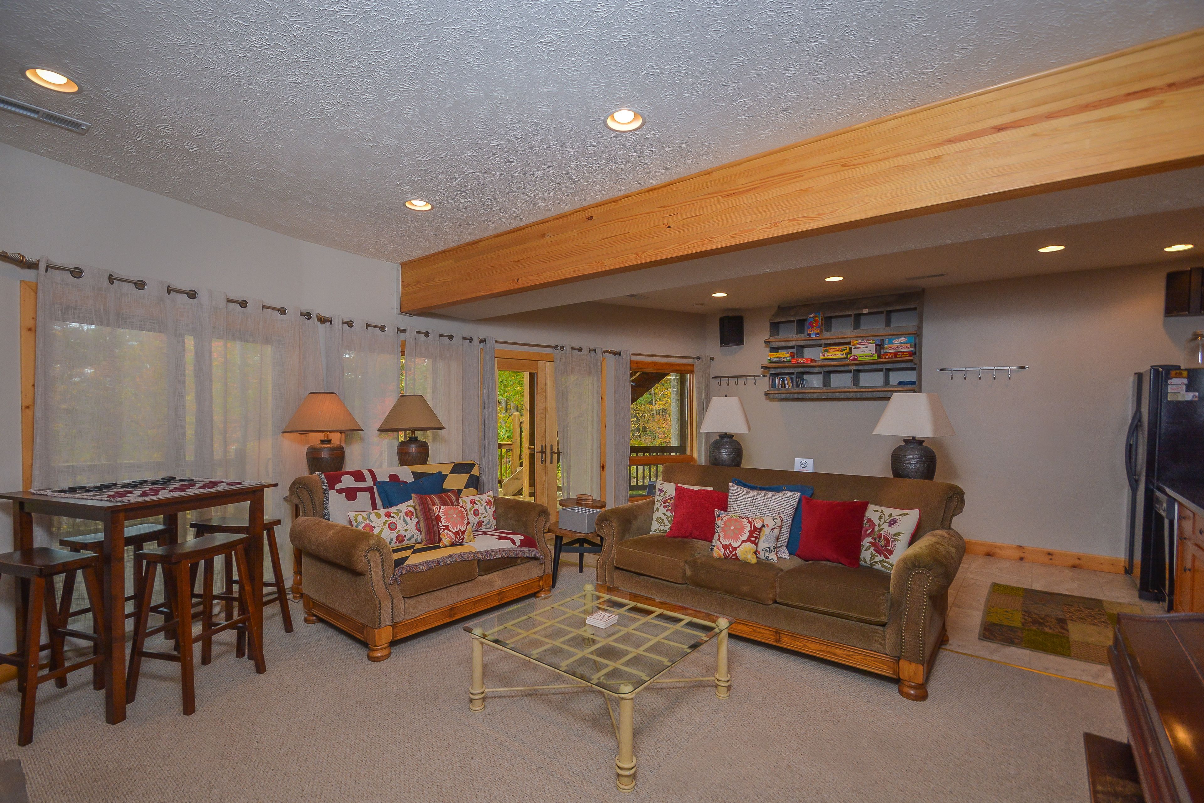 A cozy living room with two sofas, a coffee table, and a dining area with a table and chairs.