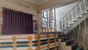A staircase with geometric patterned railings and a tiled wall with diamond shapes. - Hotel Leela Nikunj (Jaisalmer)