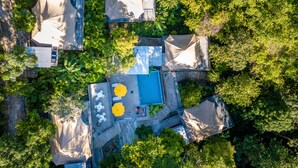 An aerial view of a resort with multiple covered outdoor areas, a swimming pool, and lush greenery. - Boulder Valley (George Town)