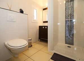 A modern bathroom with a toilet, a shower enclosure, and a sink. - Hotel Macchie E Fiori (Pianotolli-Caldarello)