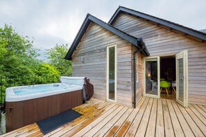 A wooden cabin with a hot tub and a deck. - Mains of Taymouth Country Estate (Aberfeldy)