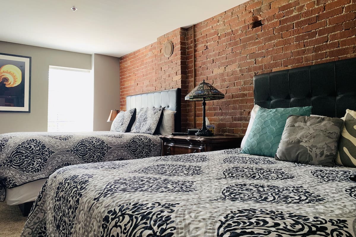 deluxe room, 2 queen beds, non smoking | individually decorated, individually furnished, desk, iron/ironing board