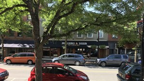 A street scene with parked cars, a tree, and a building with a sign that reads "Burgers & Beer of Morning." - Lodging at the Gaffer Inn (Corning)
