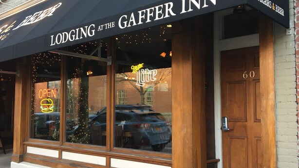 The exterior of the Gaffer Inn, featuring a neon sign, a Christmas tree, and a Miller Lite sign. - Lodging at the Gaffer Inn (Corning)