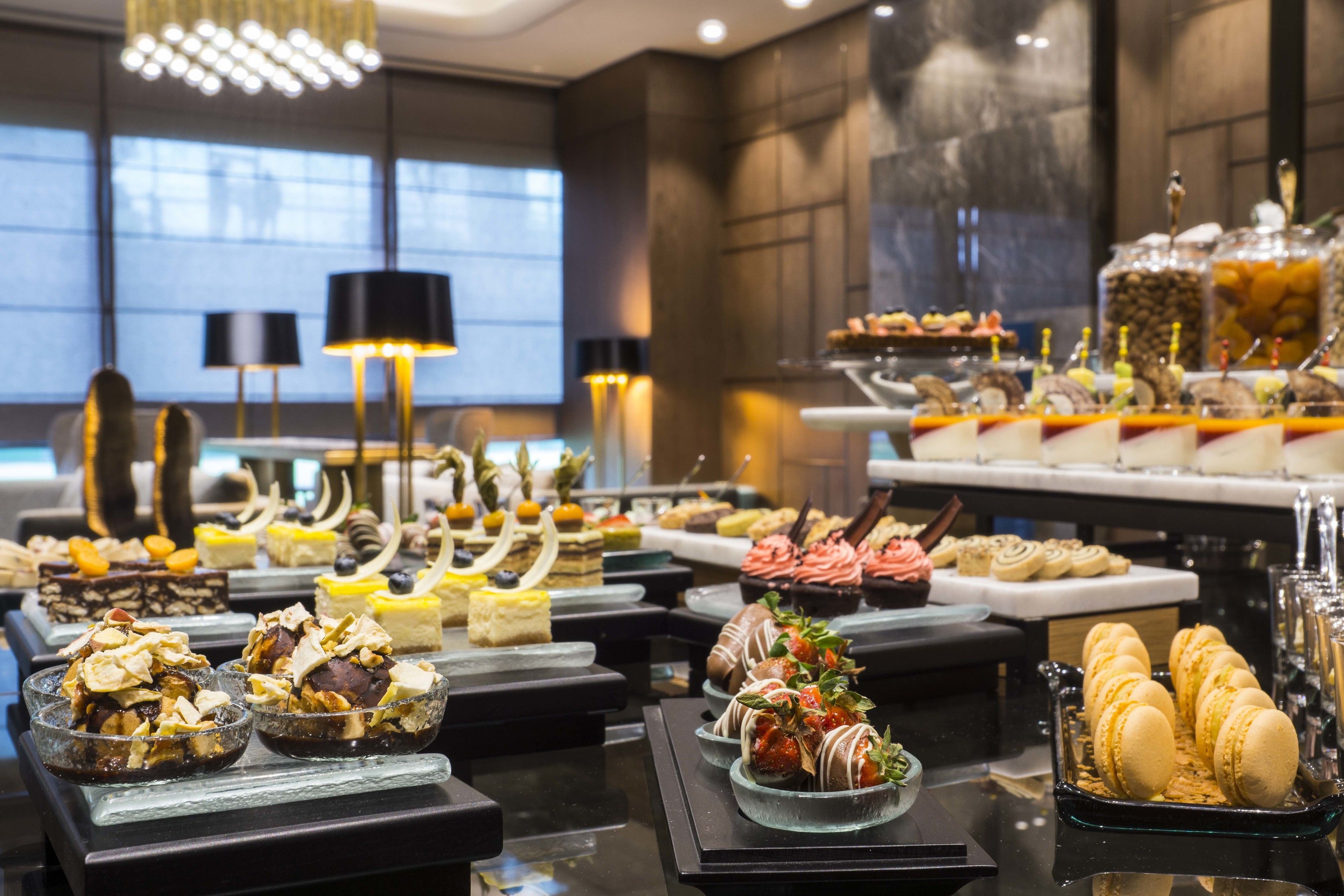 A buffet with various desserts and pastries.