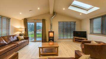 Tay Lodge | Living area | 45-inch Smart TV with digital channels, TV, fireplace