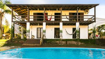 Relax on the balcony with a hammock overlooking the large swimming pool.