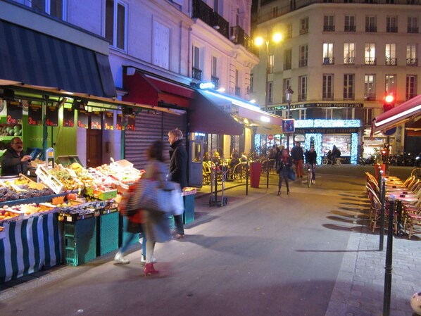 A bustling street market with vendors and shoppers.
