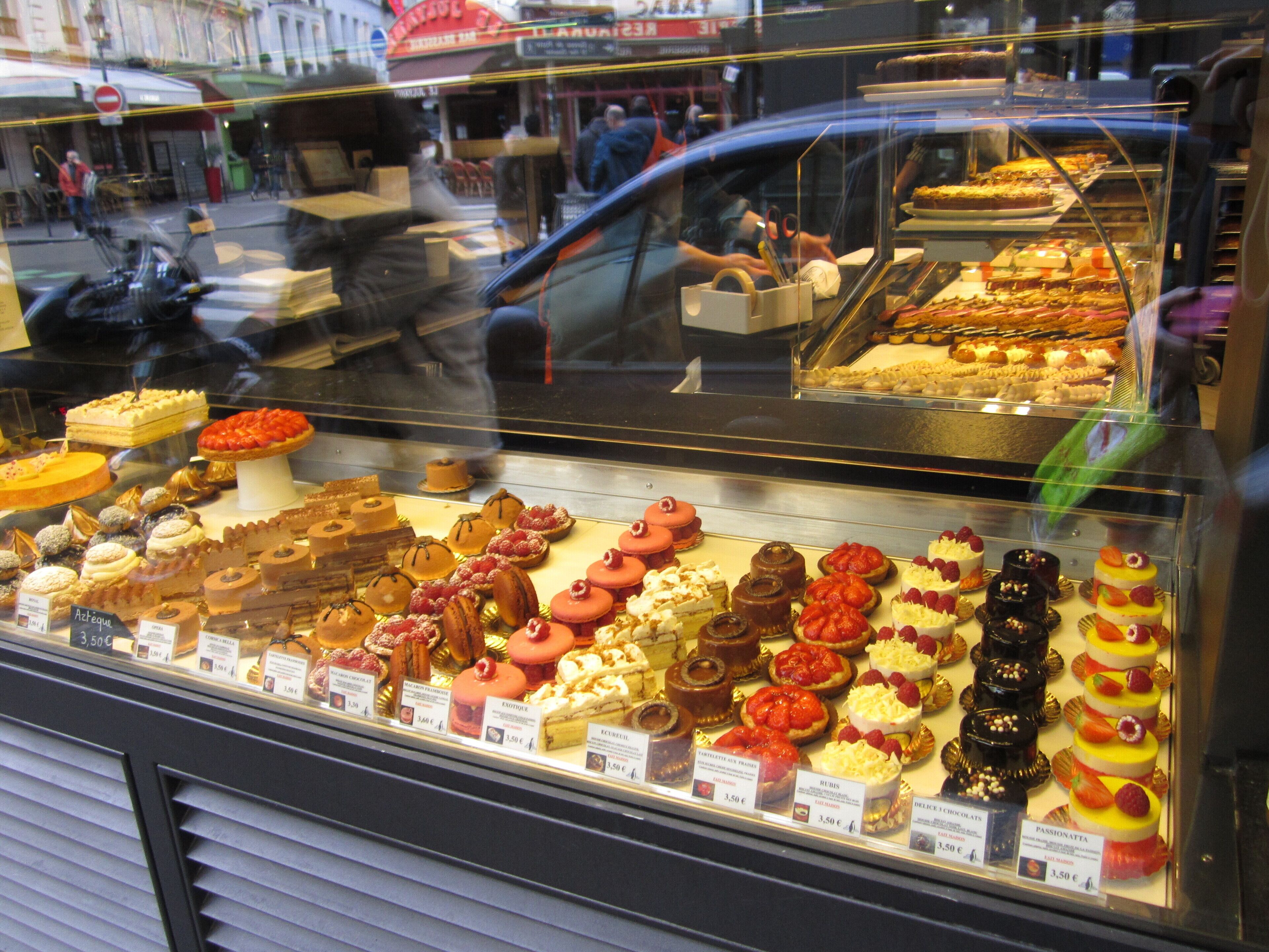 A bakery display case with various pastries and desserts.