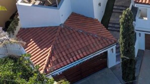 A coastal residential area with terracotta-tiled roofs, a mix of single and multi-story buildings, and a view of the sea. - OCEANFRONT! 3 DISTINCT SUITES!
 JACUZZI & BBQ! (Encinitas)