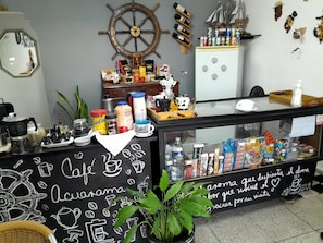 Café interior with a chalkboard wall, coffee counter, and nautical touches.