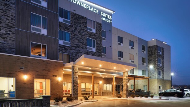 A Towneplace Suites Marriott building with a stone facade, multiple windows, and a covered entrance area. - TownePlace Suites by Marriott Jackson (Jackson)