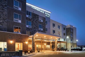 A Towneplace Suites Marriott building with a stone facade, multiple windows, and a covered entrance area. - TownePlace Suites by Marriott Jackson (Jackson)