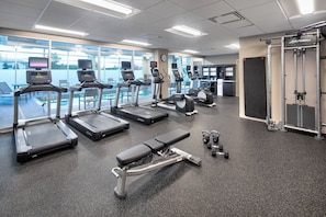 A gym with treadmills, elliptical machines, a bench, and weight equipment. - Residence Inn by Marriott Toronto Mississauga West (Mississauga)