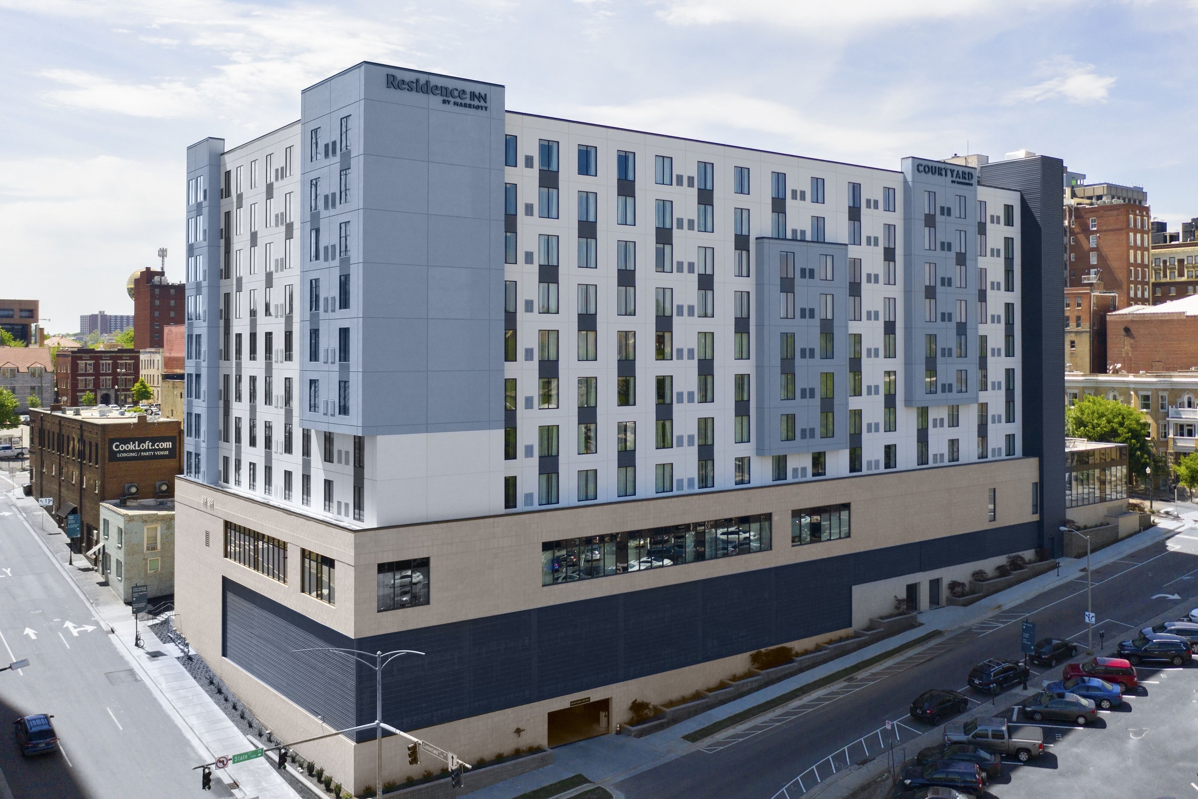 A modern hotel with a grid-like facade, large windows, and a flat roof.