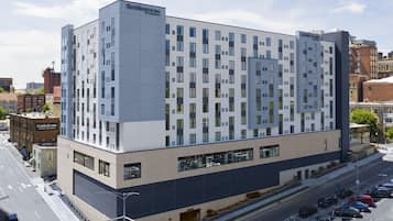 A modern hotel with a grid-like facade, large windows, and a flat roof.