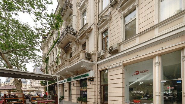 A building with a storefront labeled "InSky" and a sign for "Hotel".