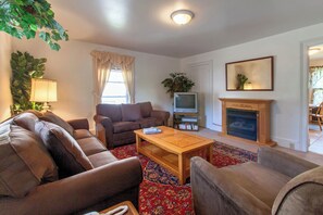 Relax in this inviting living room with a comfortable sofa, coffee table, and fireplace.