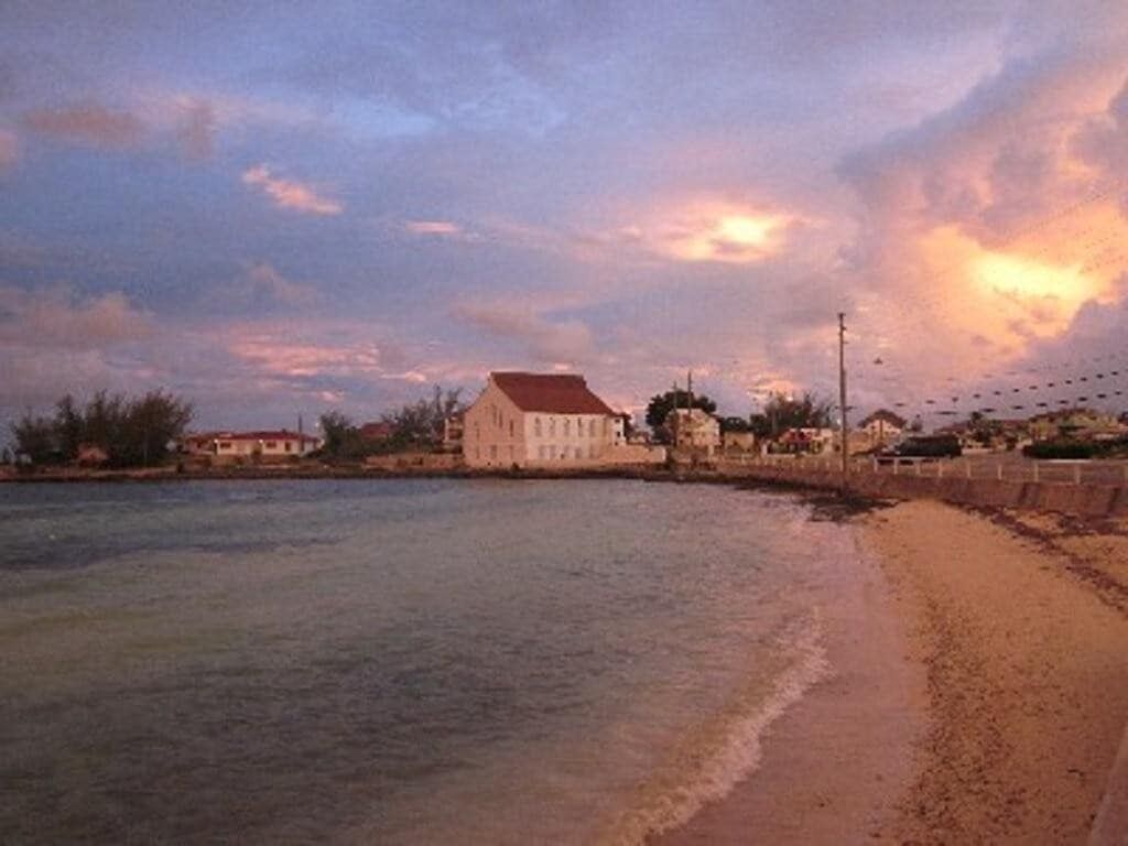 A beach with a building in the background.
