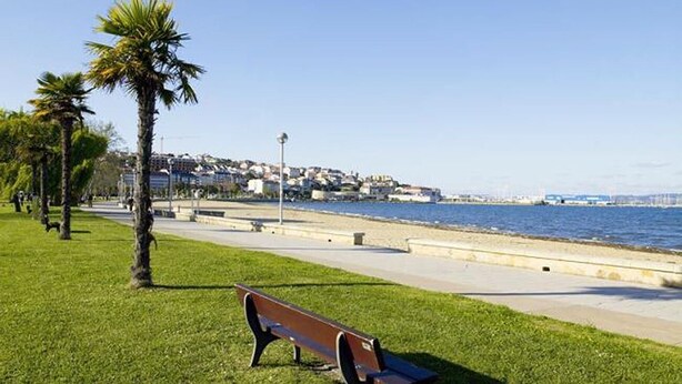 A park with a bench, palm trees, and a waterfront view. - Galician Stone Cottage for 2 people  (A Coruna)