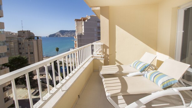 A balcony with white lounge chairs and a view of the sea. - A110 EDIFICIO LA REINA 8º 45 (Calpe)