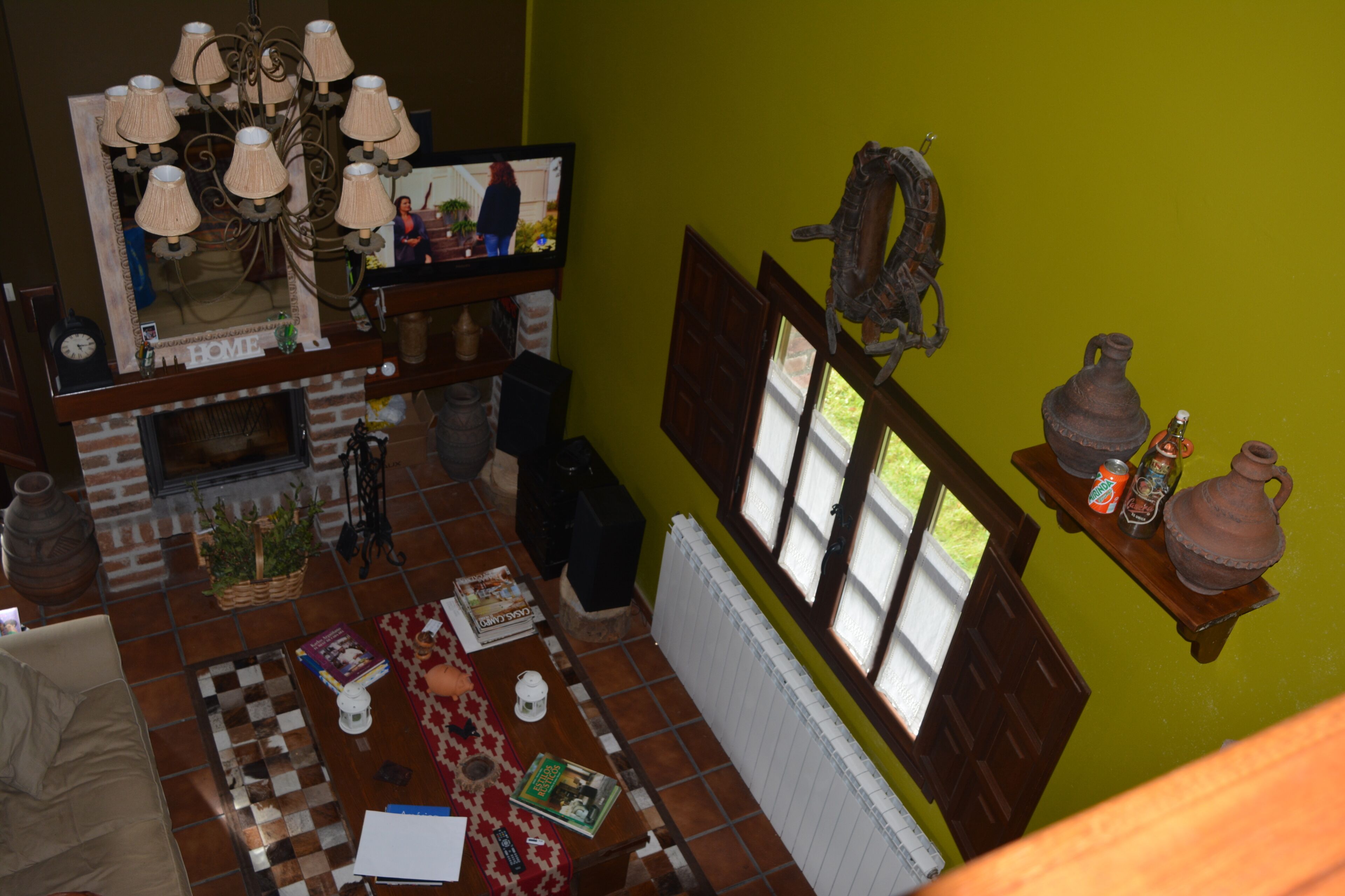 A cozy living room with a fireplace, a television, and a variety of decorative items.