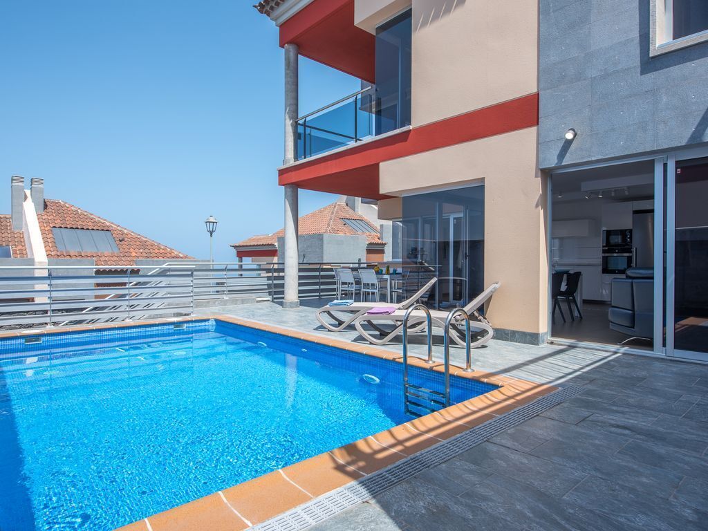 Una piscina al aire libre, una piscina climatizada, tumbonas