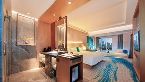 A modern hotel room with a marble bathroom, a large bed, a sitting area with a view, and a small kitchenette. - Royce Hotel Shenzhen (Shenzhen)
