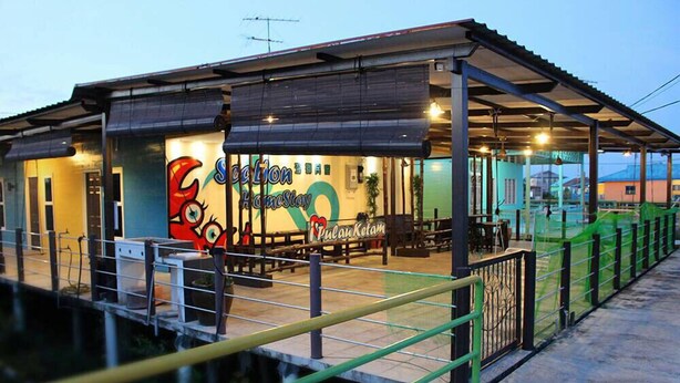 Um hotel com uma grande placa com a inscrição "Seaglio HomeStay Pulau Ketam".