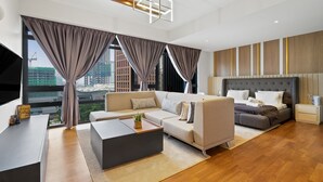 A modern hotel room with a sofa, a bed, a TV, and a view of the cityscape. - Anggun Residences Serviced Suites (Kuala Lumpur)