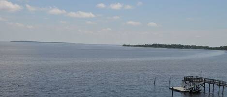 A calm lake with a dock extending into the water.