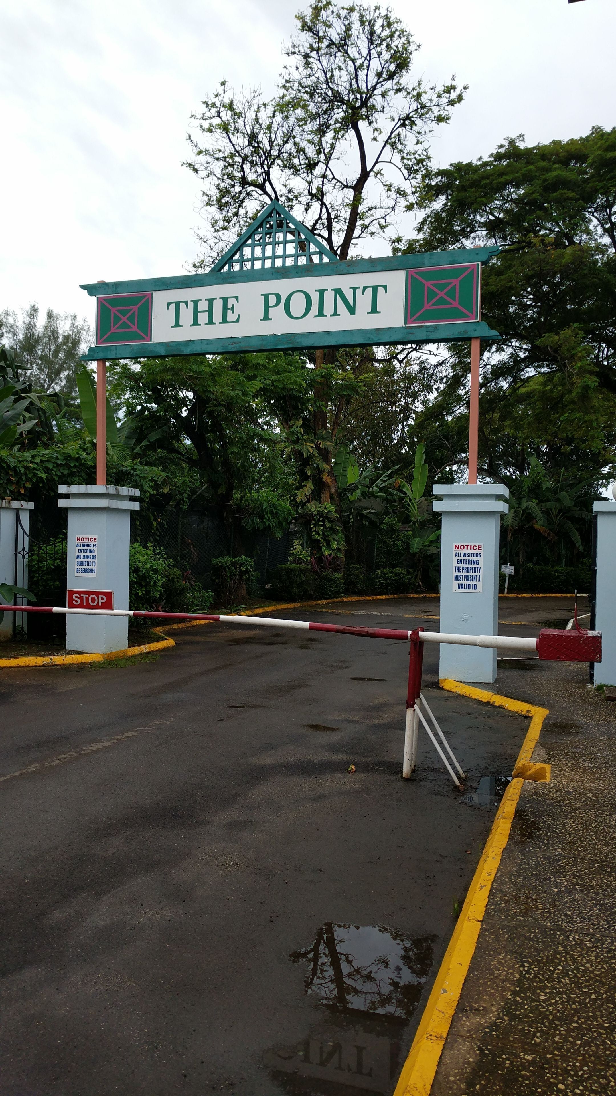 A gated entrance with a sign reading "THE POINT" and a notice requiring valid ID for entry.