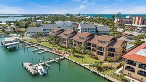 A coastal hotel with multiple buildings, a marina, and a view of the ocean. - Bay Watch - Waterfront - Walk to beach and restaurants - Dock your boat (Englewood)