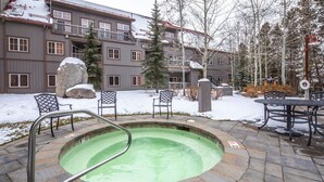 A pool area with a hot tub, stone steps, and outdoor furniture. - 8562 | Pool & Hot tub OPEN, Steps to Gondola. (Keystone)