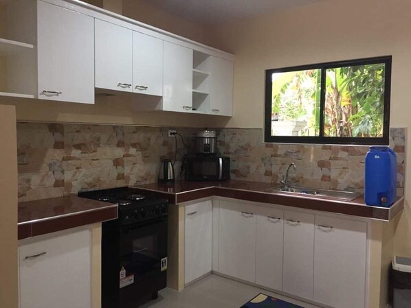 Exclusive Apartment, 2 Queen Beds, Non Smoking | Private kitchen | Fridge, microwave, oven, cookware/dishes/utensils - Cris Place Dumaguete (Valencia)