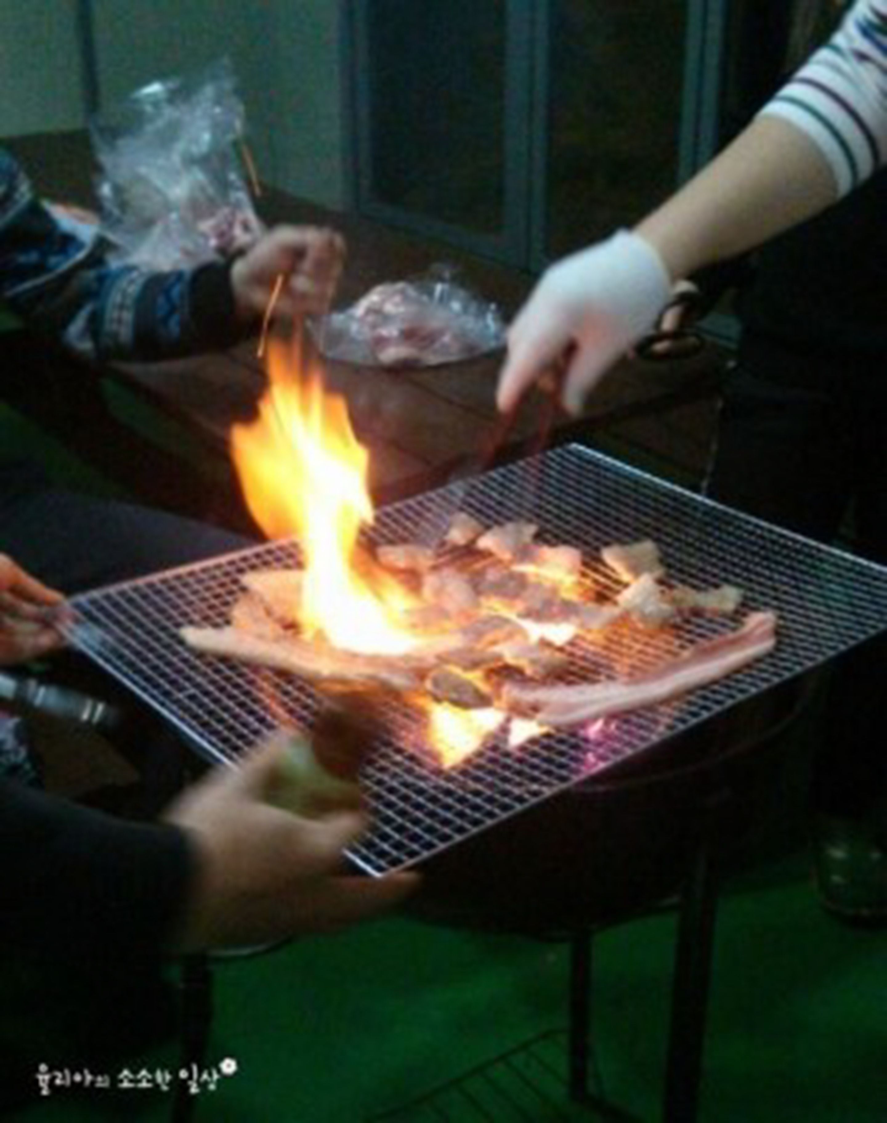 A grill with food being cooked over an open flame.